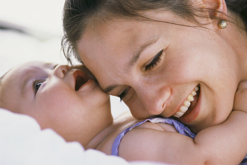 Mother Resting Head on Infant's Chest