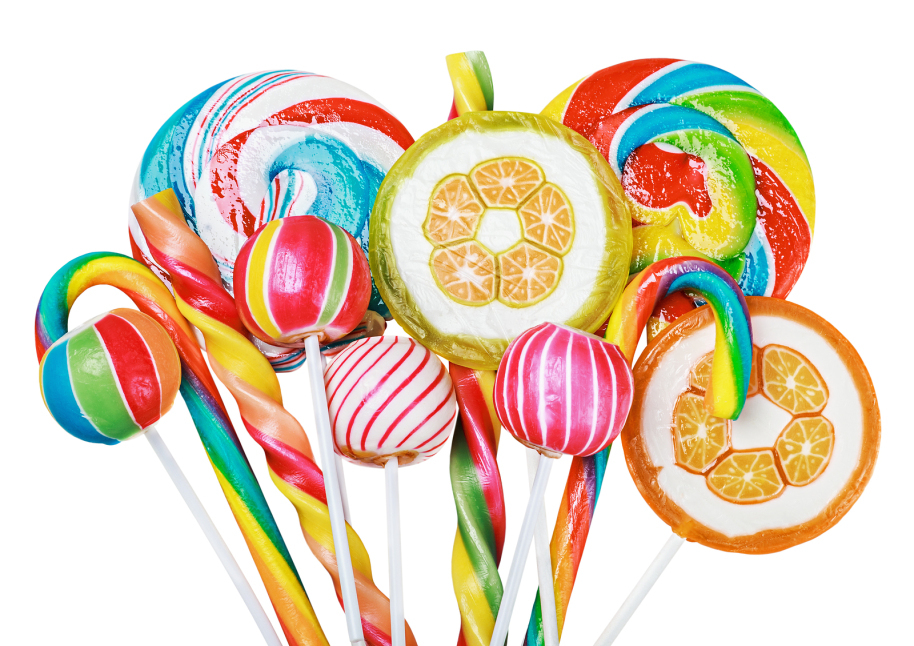 Colorful candies and lollipops isolated on white background.